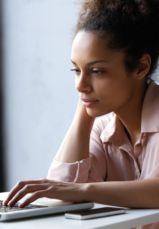 Young black woman looking at laptop hero