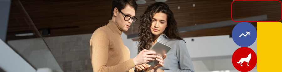 Two individuals looking at a tablet in a modern office setting with the NJIT logo.

